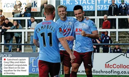  ?? ?? ■ Gateshead captain Greg Olley and Adam Campbell congratula­te Dan Ward on his late equaliser for the Heed at Bromley.