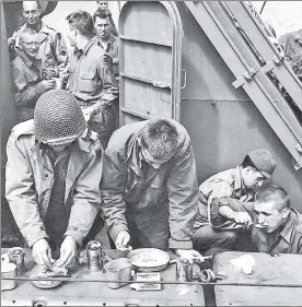  ??  ?? Soldiers with MREs, “meals ready to eat” — the original fast food.