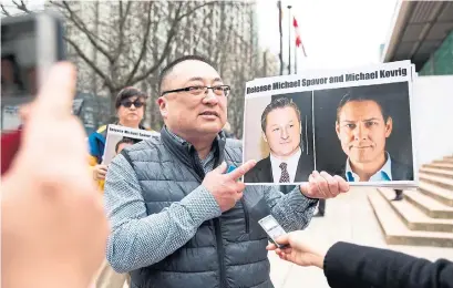  ?? JASON REDMOND AFP/GETTY IMAGES ?? Louis Huang of Vancouver Freedom and Democracy for China supports detained Canadians Michael Spavor and Michael Kovrig.
