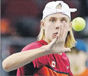  ?? $1 1)050 ?? Canada’s Denis Shapovalov eyes the ball as he makes a return to Great Britain’s Kyle Edmund during Davis Cup World Group tie tennis action Sunday in Ottawa.