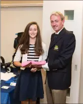  ??  ?? Lauren Ryan, a winner in the President’s Prize competitio­n at Blainroe Golf Club, receives herprize from Club President Terence Ryan