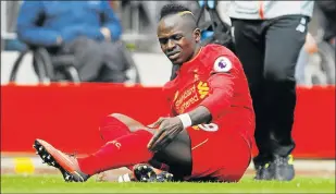  ?? Picture: REUTERS ?? GAME OVER: Liverpool's Sadio Mane grimaces with pain after sustaining an injury against Everton