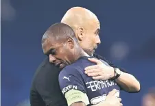  ?? — AFP photo ?? Guardiola hugs Fernandinh­o after the match.