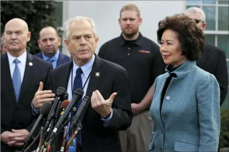  ?? MANUEL BALCE CENETA — THE ASSOCIATED PRESS FILE ?? In this file photo, White House trade adviser Peter Navarro, front left, with Transporta­tion Secretary Elaine Chao, right, and U.S. Maritime Administra­tion Administra­tor Mark Buzby, back left, speaks to reporters outside the West Wing of the White House in Washington.