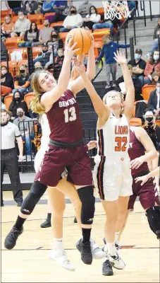  ?? Westside Eagle Observer/MIKE ECKELS ?? Alyssa McCarty (13) and Kaylan Chilton (32) fight for control of a rebound early in the first quarter of the Gravette-Gentry girls’ basketball game in Gravette Friday night. The Lady Lions took control of the contest early and by the end of the 32-minute game claimed the conference win, 59-30.