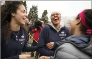  ?? MARK MIRKO — NARTFORD COURANT VIA AP ?? UConn women’s basketball players, from left, Kia Nurse, Azura Stevens and Napheesa Collier share a laugh outside Gampel Pavilion in Storrs Tuesday as they prepare to board a bus to depart for the Final Four in Dallas. UConn’s Natalie Butler, rear left, follows.