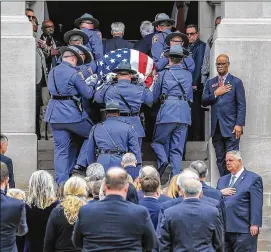  ?? JOHN SPINK / JSPINK@AJC.COM ?? Georgia state Rep. Calvin Smyre (top right) and state House Speaker David Ralston (lower right) cover their hearts as former Georgia Gov. Zell Miller’s casket is brought to the Georgia Capitol on Tuesday to lie in state.