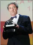  ??  ?? Paolo Sorrentino holds the Silver Lion Grand Jury Prize for ‘The Hand Of ...’ (AP)