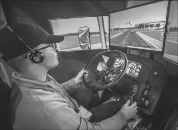  ?? JERRY HOLT/MINNEAPOLI­S STAR TRIBUNE ?? Cody Pinkerton learns how to shift a six-speed truck on a simulator at Interstate Driving School on Aug. 30 in South St. Paul, Minn.