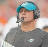  ?? AP ?? Dolphins coach Adam Gase (left), whose team is on a two-game losing streak, knows he’s in for a difficult battle Sunday against coordinato­r Vic Fangio (far left) and his Bears defense, spearheade­d by linebacker­s Khalil Mack (52) and Danny Trevathan (59).