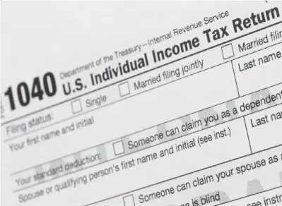  ??  ?? ABOVE:
A portion of the 1040 U.S. Individual Income Tax Return form
is shown July 24, 2018. Tax time is an inevitable reminder to organize important documents. Begin by knowing what to keep and for how long. Then, decide on a system for finding the documents you need when you need them. Choose a method you’ll feel confident using, whether that’s digitizing everything or putting papers in a file cabinet.