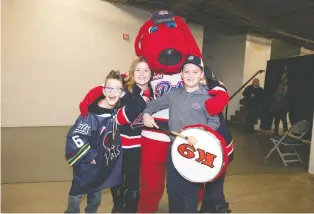  ?? PHOTOS: TROY FLEECE ?? Austin Wagman, left, and friends having a blast with the Regina Pats team mascot, K9.