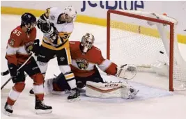  ?? DAVID SANTIAGO/MIAMI HERALD ?? Panthers goalie Roberto Luongo can’t stop Penguins left winger Conor Sheary’s shot during the first period on Thursday at BB&T Center.