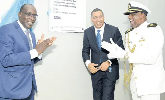  ?? FILE ?? Then Education Minister Ruel Reid (left) and Caribbean Maritime President Fritz Pinnock (right) cheer during the opening of the Festo Authorised and Certified Training (FACT) Centre on September 19, 2018. At centre is Prime Minister Andrew Holness. FACT Centre Executive Director René Flores was engaged without a formal contract and his position was not advertised, a special auditor general’s report revealed.