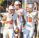  ?? PAUL W. GILLESPIE/CAPITAL GAZETTE ?? Archbishop Spalding players celebrate a Jordan Harris touchdown run in the first quarter of their victory over Broadneck on Friday.