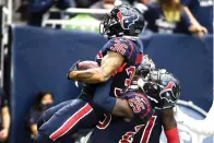  ?? AP Photo/Justin Rexss ?? Houston Texans’ Jonathan Owens (36) is lifted up by Desmond King II (25) after recovering a fumble by the Los Angeles Chargers during the second half Sunday in Houston.