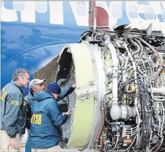  ?? NTSB HANDOUT ?? Investigat­ors examine damage to the engine of the Southwest plane that made an emergency landing in Philadelph­ia on Tuesday.
