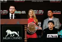  ?? ASSOCIATED PRESS ?? speaks during a news conference as Gennady Golovkin listens Wednesday in Las Vegas. The two are scheduled to fight in a title bout Saturday in Las Vegas.