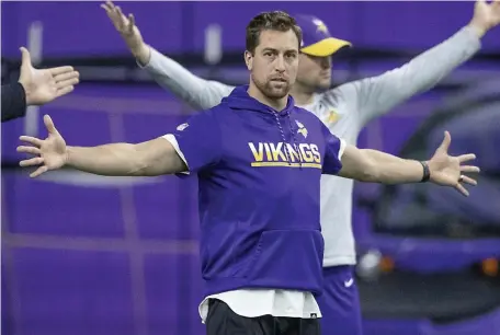  ?? AP FILe PHOTOs ?? MAKING DO: Vikings wide receiver Adam Thielen stretches before practice at the Twin Cities Orthopedic Center in Eagan, Minn., in 2019. Below, new Tampa Bay quarterbac­k Tom Brady runs across the field at Berkeley Preparator­y School in Tampa, Fla., during an unofficial workout with players.