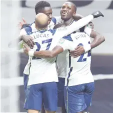  ?? Photo — AFP ?? Tottenham Hotspur’s midfielder (right) celebrates with teammates after he scores his team’s first goal during the English League Cup semi final first leg match against Brentford at Tottenham Hotspur Stadium in London.