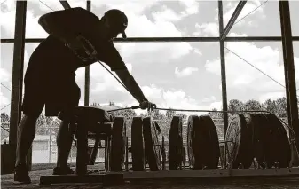  ?? Jason Fochtman / Staff photograph­er ?? Magnolia coaches secure weights at required distances at the high school’s facility. UIL programs can open strength and conditioni­ng sessions starting Monday.