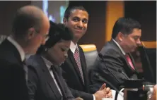  ?? Alex Wong / Getty Images ?? FCC Chairman Ajit Pai smiles during the meeting Thursday when the panel voted to repeal net neutrality.