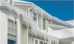  ?? CHRISTIAN DELBERT/DREAMSTIME ?? Heavy icicles are a sign of roof dams, which can be damaging to your roof and need to be addressed quickly.
