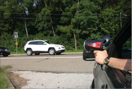  ?? MEDIANEWS GROUP FILE PHOTO ?? A state trooper uses a radar gun to see how fast drivers are going during a crackdown on speeding.