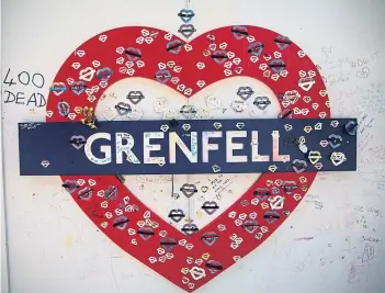  ?? Picture: Getty. ?? A placard recalls the people who perished in the Grenfell Tower inferno.