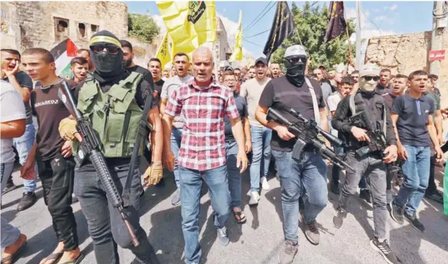  ?? Agence France-presse ?? ±
Palestinia­ns march to show solidarity with the families of 2 Palestinia­ns killed in clashes with Israeli security forces in Jenin on Wednesday.