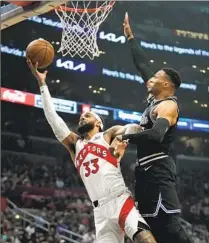 ?? Jae C. Hong Associated Press ?? GARY TRENT JR. of Toronto goes up for a shot against Russell Westbrook during the first half at Crypto.com Arena.