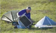  ?? STAFF PHOTO BY ANGELA LEWIS FOSTER ?? Eric Freimark sets up solar panels Thursday that will power tornado-monitoring equipment in Mountain Cove Farms.