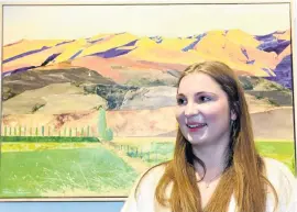  ?? PHOTOS: LINDA ROBERTSON ?? Young artist . . . University of Otago student Polina Collins stands in front of her winning entry Sunset in Central Otago in the youth category for the Hope and Sons Art Awards 2024 at the Otago Art Society in the Dunedin Railway Station yesterday.