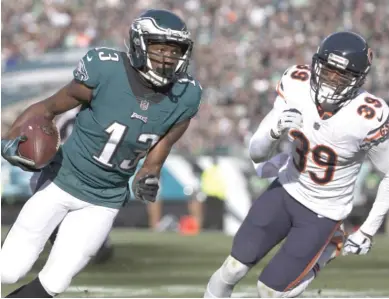  ??  ?? Eagles wide receiver Nelson Agholor runs past Bears rookie safety Eddie Jackson en route to a 15- yard touchdown in the second quarter last Sunday at Lincoln Financial Field.
| MITCHELL LEFF/ GETTY IMAGES