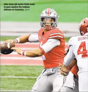  ??  ?? Ohio State QB Justin Fields looks to pass against the Indiana defense on Saturday.