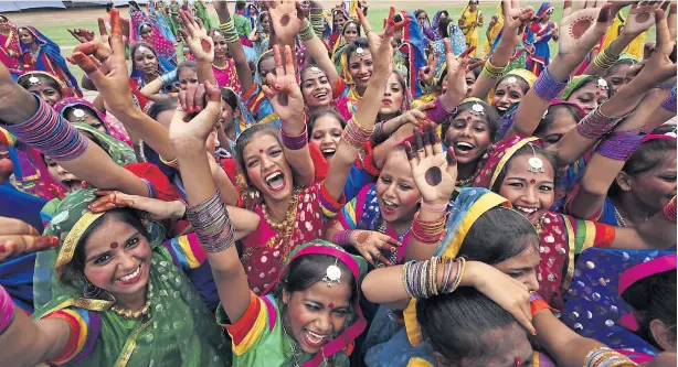  ?? REUTERS ?? Schoolchil­dren celebrate after they perform during India’s Independen­ce Day celebratio­ns in Chandigarh, India, on Saturday. Indian Prime Minister Narendra Modi’s speech focused on measures his “Team India” had rolled out to include millions of poor...