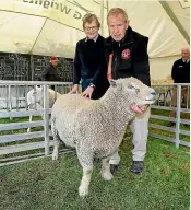  ??  ?? Ellen and Graham Calder, of Kennington, with their Hall Genetics Southdown Ram, which was named Supreme Sheep. The ram is three shear age and won the Southdown class, before taking the supreme win.