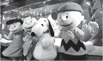  ??  ?? Snoopy and the “Peanuts” gang join Macy’s on Herald Square to unveil Christmas windows celebratin­g the 50th anniversar­y of the holiday classic, “A Charlie Brown Christmas,” in New York.