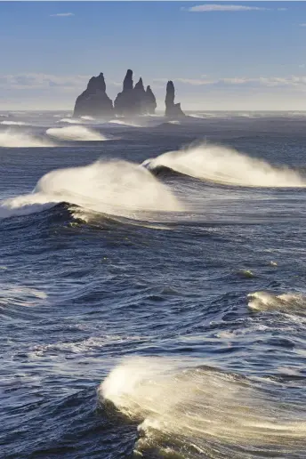  ??  ?? Hellisheið­i geothermal power plant, the largest in Iceland (above left); waves off Reynisfjar­a Beach, with the Reynisdran­gar rock formations in the distance (right)