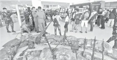  ?? ALDO NELBERT BANAYNAL ?? Some military weapons are shown at the Kagawasan 2018, a photo static display and exhibit, at Ayala Center Cebu. Part of the exhibit is Cebu's longest running newspaper, The Freeman, which will celebrate its 99th year in July.