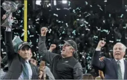  ?? MATT SLOCUM — THE ASSOCIATED PRESS ?? Eagles general manager Howie Roseman, left, holds up the Vince Lombardi Trophy as he celebrates with head coach Doug Pederson, center, and owner Jeffrey Lurie last Sunday in Minneapoli­s.