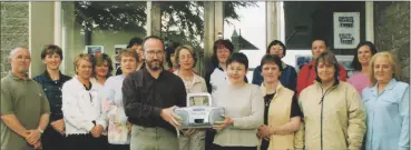  ?? ?? Martin O’Sullivan, chairman of Bunscoil na Toirbhirte Parents’ Council, Mitchelsto­wn, along with members of the parents council, presenting Catherine Horgan, vice principal with one of twelve CD players presented to the school during the school year in 2002.