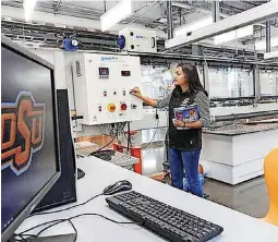  ??  ?? Oklahoma State University senior Joanna Quiah, a biosystems engineerin­g major from Edmond, talks about the equipment in the flow lab in the new Endeavor building.