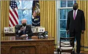  ?? EVAN VUCCI — THE ASSOCIATED PRESS ?? Secretary of Defense Lloyd Austin listens as President Joe Biden speaks before signing an Executive Order in the Oval Office on Monday.