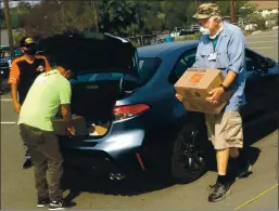  ?? THOMAS GASE — TIMES-HERALD ?? Veterans help out other veterans at Rebuilding Together Food Giveaway event in Vallejo on Saturday.