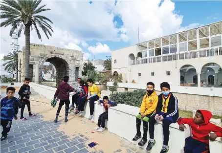  ?? File/AFP ?? Youths sit outdoors in a square of the Libyan capital Tripoli’s old city amid ongoing infrastruc­ture rehabilita­tion projects.