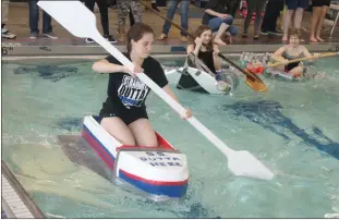  ??  ?? Henry Lackey High School senior Courtney Alvey of the “S.S. Outta Here” team took an early lead in the school’s recycled boat race Monday.