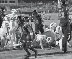  ?? RICHARD SHIRO/AP ?? Coastal Carolina's Reese White, center, scores a touchdown against BYU on Saturday.