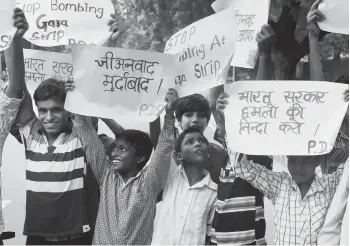  ?? — PTI ?? Children hold placards during a protest by the CPI( M) in front of the Israel embassy in New Delhi on Saturday against the military strikes on Gaza.