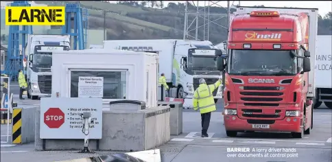  ??  ?? BARRIER A lorry driver hands over documents at control point